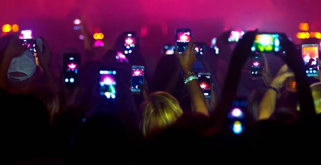 Aerosmith fans are on their cell phones Saturday, Aug. 1, 2015, at MGM Grand Garden Arena.