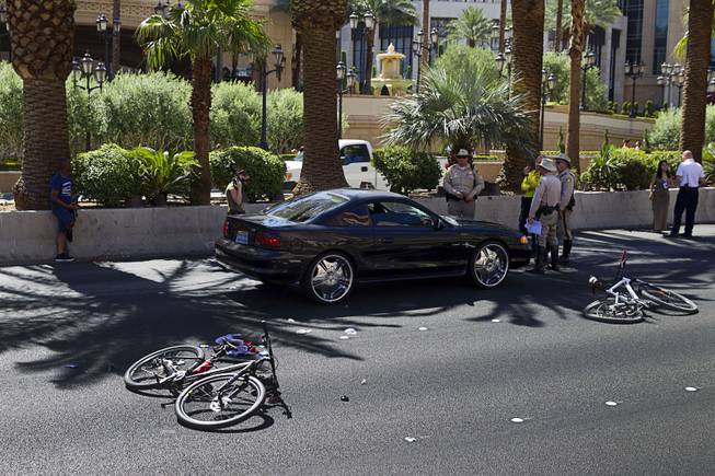 Metro Police investigate an accident involving a car and bicycle on the Las Vegas Strip in front of the Treasure Island Aug. 3, 2015. The southbound lanes of Las Vegas Boulevard in front of Treasure Island are closed during the investigation.