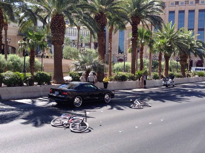 Metro Police investigate a crash involving a bicyclist and a car Monday, Aug. 3, 2015, on the Las Vegas Strip. The accident closed the southbound lanes of the Strip near Treasure Island.