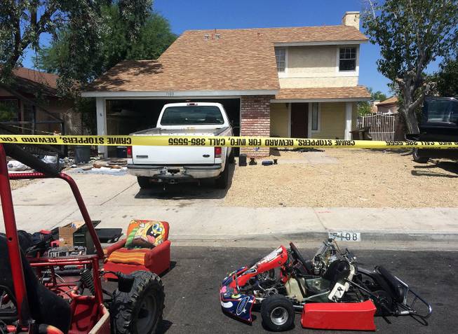 Stolen items are shown in front of a home in the 7100 block of Gunslinger Street, near East Warm Springs Road and the 215 Beltway, Friday, Aug. 7, 2015.