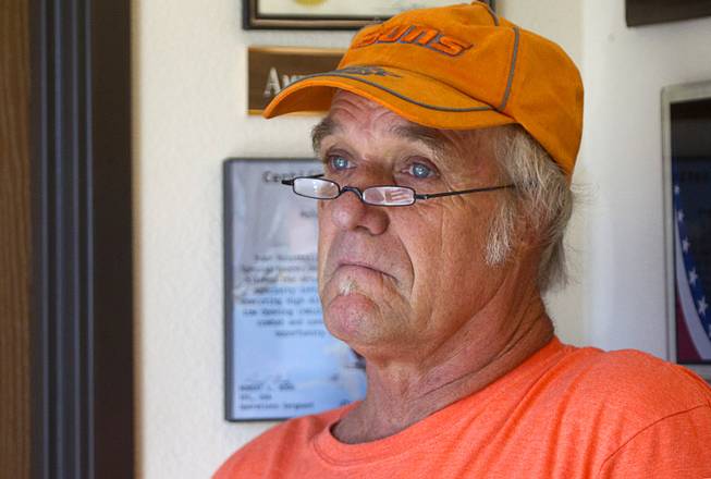 Terry King reflects on the damage inflicted by the Willow Fire during an interview in the lobby of the Mohave Valley Fire Station 81 in Mohave Valley, Ariz. Monday, Aug. 10, 2015. King's home was among eleven homes reported to have been destroyed in the Willow Fire.