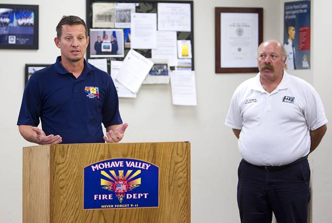 Alan Sinclair, incident commander for Southwest Area Incident Management Team 3, and Mohave Valley Fire Department Division Chief Harley Harmon give a media briefing on the Willow Fire at Mohave Valley Fire Station 81 in Mohave Valley, Ariz. Monday, Aug. 10, 2015. Eleven homes are reported to have been destroyed in the blaze.