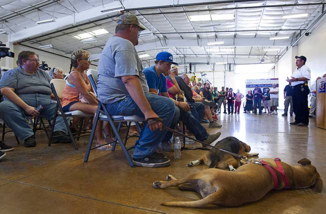 Displaced residents listen to Fire Marshal Don Gibson, right, during a public meeting on the Willow Fire at Mohave Valley Fire Station 81 in Mohave Valley, Ariz. Monday, Aug. 10, 2015. Eleven homes are reported to have been destroyed in the blaze.