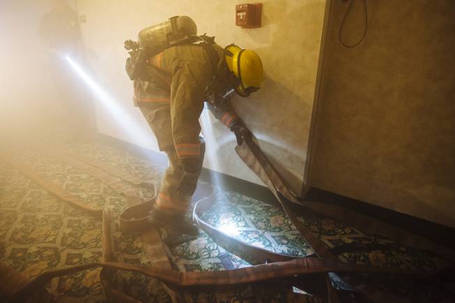 Clark County and Henderson firefighters participate in a high-rise training scenario at the site of the Riviera Hotel in Las Vegas, Nev. on Aug. 10, 2015.