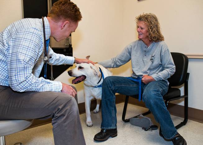 Dr. Andrew Vaughan visits with Shannon Skinner and her dog Gunner who has been an oncology patient within the ward at the Las Vegas Specialty Veterinary Center which has seen a long-term increase in the number of pets it's treating for cancer on Thursday, August 6, 2015.
