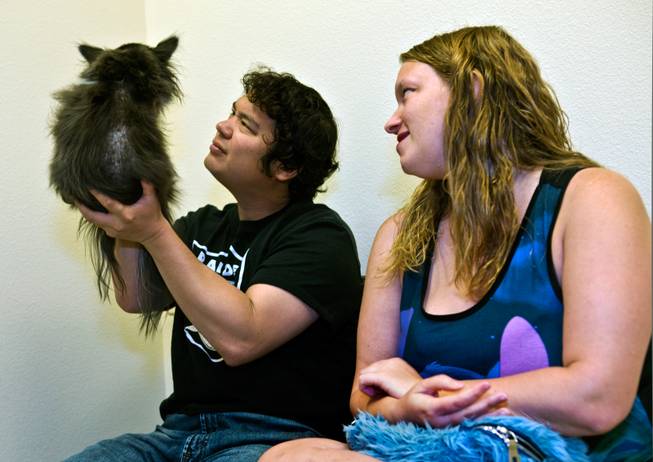 Orca the dog is checked over by owners Joe and Heather Turk after a visit to the oncology ward within the Las Vegas Specialty Veterinary Center on Thursday, August 6, 2015.