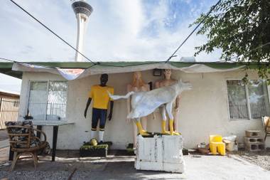 Sculptures by Rafael Espino reside outside his home on July 30, 2015.