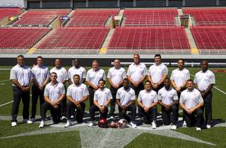 The UNLV football coaching staff poses for a photo during media day at Sam Boyd Stadium Thursday, Aug. 13, 2015.