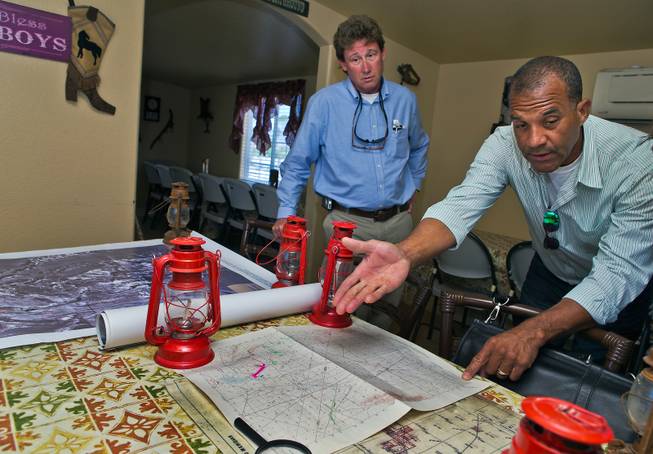 Lawyer Joe Becker with the NPRI and pastor Victor Fuentes review one of the many historical maps acquired of the current Patch of Heaven church camp property on Tuesday, July 28, 2015.