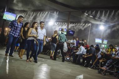 Guests walk across the dance floor while waiting for the next band to play at Broadacres Marketplace in Las Vegas, Nev. on Aug. 14, 2015.