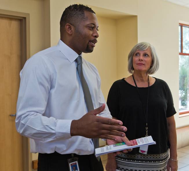 Dr. Aaron Bomer, social services director, and Jo Malay, hospital administrator, talk with others within the Rawson Neal Psychiatric Hospital about the Southern Nevada Adult Mental Health Services campus on Wednesday, August 12, 2015.
