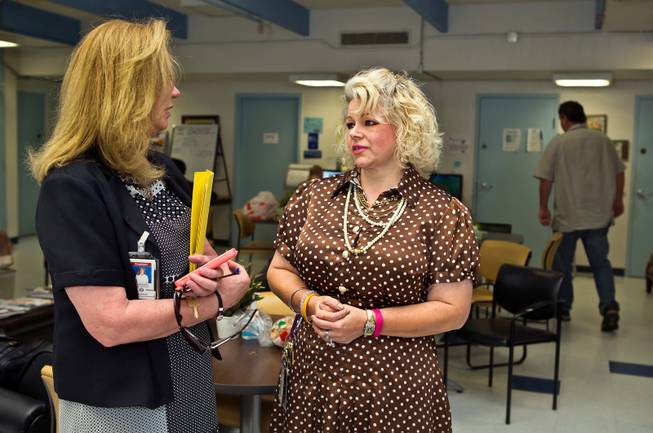Chelsea Szklany, Deputy Administrator of Clinical Services, chats with Jo Anna Rios, a consumer services assistant, within The Drop In Center on the Southern Nevada Adult Mental Health Services campus on Wednesday, August 12, 2015.
