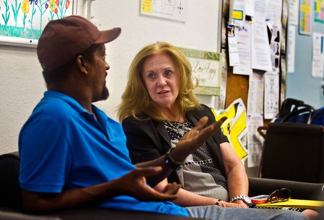 Visitor Boris Collins engages in a conversation with Chelsea Szklany, Deputy Administrator of Clinical Services, within The Drop In Center on the Southern Nevada Adult Mental Health Services campus on Wednesday, August 12, 2015.