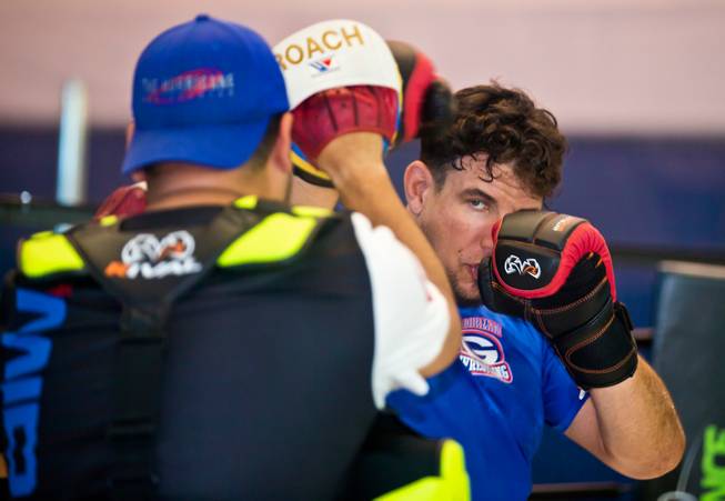UFC fighter Frank Mir, right, throws punches with trainer Angelo Reyes during training at Hybrid Performance in preparation for his Labor Day weekend fight in the co-main event of UFC 191 against Andrei Arlovski on Friday, August 14, 2015.
