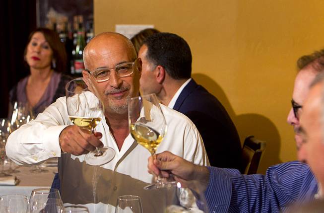 Giovanni Nencini, left, managing director of Lux Wines, toasts with a guest during a Taste & Learn wine event at Ferraro's Italian Restaurant & Wine Bar, 4480 Paradise Rd., Saturday, Aug. 22, 2015.