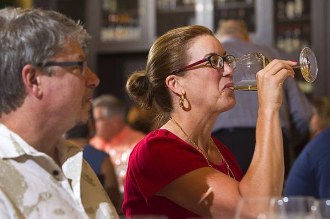 Crystal Logan tries some wine during a Taste & Learn wine event at Ferraro's Italian Restaurant & Wine Bar, 4480 Paradise Rd., Saturday, Aug. 22, 2015.