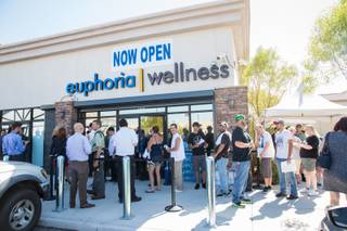Dozens of customers wait in line to purchase marijuana on Monday, Aug. 24, 2015, opening day of Euphoria Wellness, the first marijuana dispensary in Las Vegas.