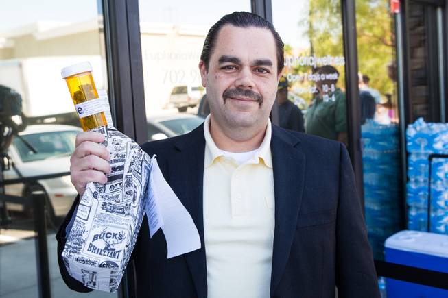 David Cobbett is one of the first customers to purchase marijuana on opening day of Euphoria Wellness, the first marijuana dispensary in Las Vegas, Monday, Aug. 24, 2015.