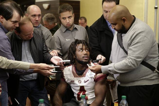 In this Dec. 29, 2014, file photo, Florida State running back Dalvin Cook, center, is surrounded by reporters during the team's media day, for the Rose Bowl, in Los Angeles. 