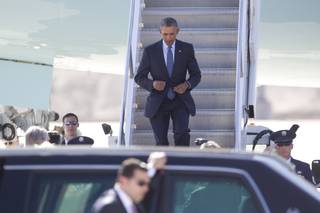 President Barack Obama steps off Air Force One as he arrives at McCarran International Airport on Monday, Aug. 24, 2015, in Las Vegas to give remarks at the National Clean Energy Summit 8.0.