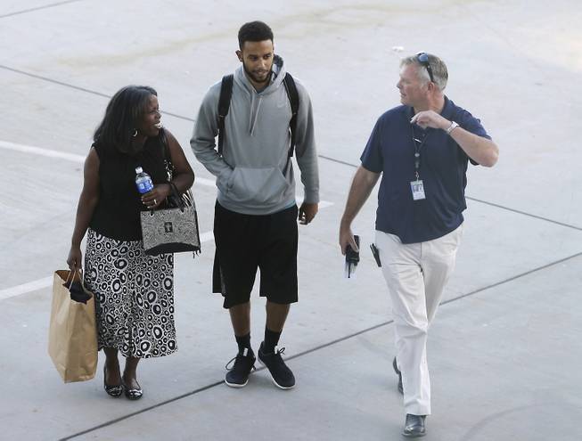 Anthony Sadler, center, who helped stop a terror attack on a high-speed train traveling from Amsterdam to Paris, walks across the tarmac to a waiting vehicle at Sacramento International Airport, Tuesday, Aug. 25, 2015, in Sacramento.