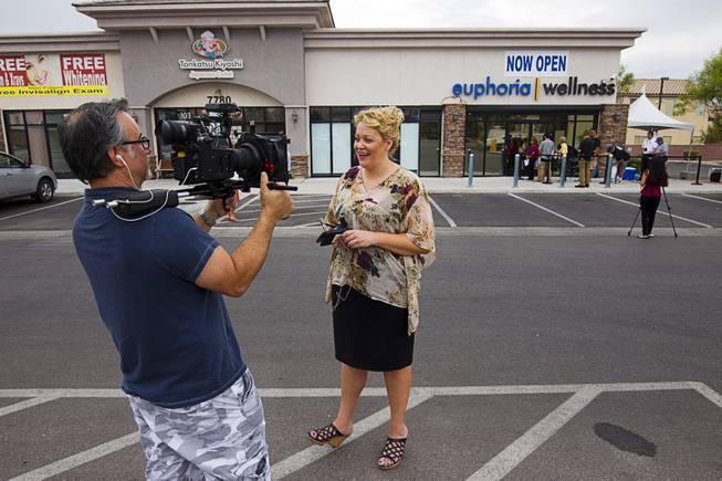 Darlene Purdy, managing director, is filmed during the public opening of Euphoria Wellness, 7785 S. Jones Blvd., the first medical marijuana dispensary in Las Vegas, Wednesday, Aug. 26, 2015. An opening on Monday was only available to preregistered patients.