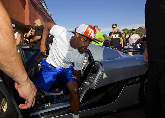 Floyd Mayweather Jr. arrives in his new $4.8 million Koenigsegg CCXR Trevita for a workout at the Mayweather Boxing Club Wednesday, Aug. 26, 2015.