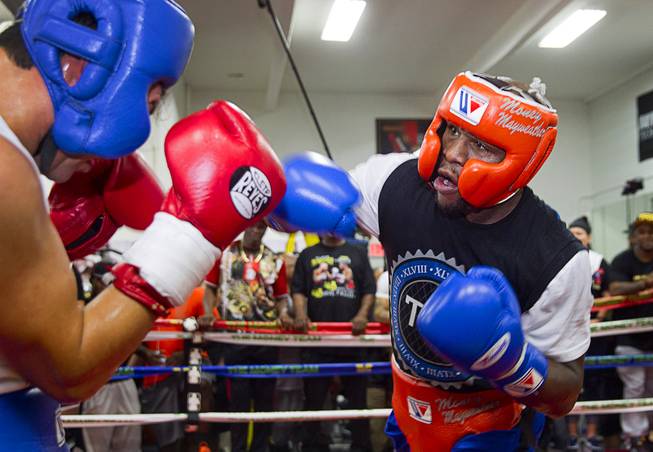 Floyd Mayweather Jr., right, punches at Ramon Montano during a sparring session at the Mayweather Boxing Club Wednesday, Aug. 26, 2015. Mayweather will defend his WBC and WBA welterweight titles against Andre Berto on Sept. 12 at the MGM Grand Garden Arena.
