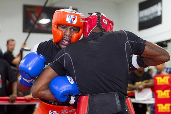 Floyd Mayweather Jr., left, spars with Don Moore at the Mayweather Boxing Club Wednesday, Aug. 26, 2015. Mayweather will defend his WBC and WBA welterweight titles against Andre Berto on Sept. 12 at the MGM Grand Garden Arena.