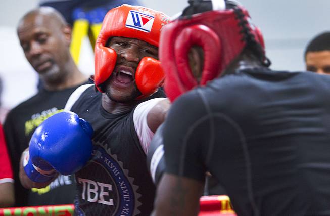 Floyd Mayweather Jr. left, punches at sparring partner Don Moore at the Mayweather Boxing Club Wednesday, Aug. 26, 2015. Mayweather will defend his WBC and WBA welterweight titles against Andre Berto on Sept. 12 at the MGM Grand Garden Arena.