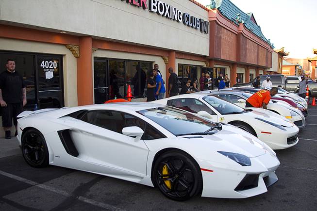 An assortment of Floyd Mayweather Jr.'s super cars are parked in front of the Mayweather Boxing Club during a workout Wednesday, Aug. 26, 2015.
