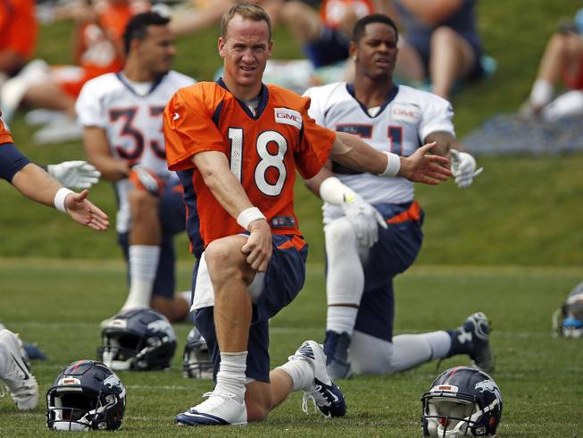 Denver Broncos quarterback Peyton Manning stretches before facing the San Francisco 49ers in a football scrimmage at Broncos’ headquarters Thursday, Aug. 27, 2015, in Englewood, Colo. 