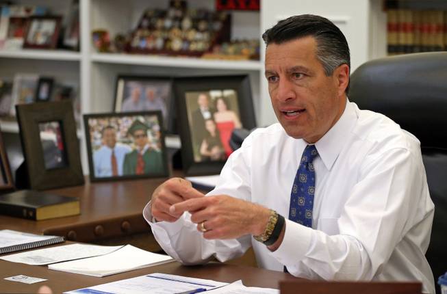 Gov. Brian Sandoval is shown in his office April 17, 2015, at the Capitol in Carson City. The Republican is refusing to release any text messages he's had with NV Energy representatives despite a public records request.