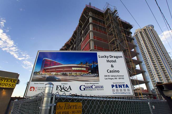 A sign showing an artist's illustration of the Lucky Dragon Hotel & Casino is posted at the casino's construction site,300 W. Sahara Ave., Sunday, Aug. 30, 2015.