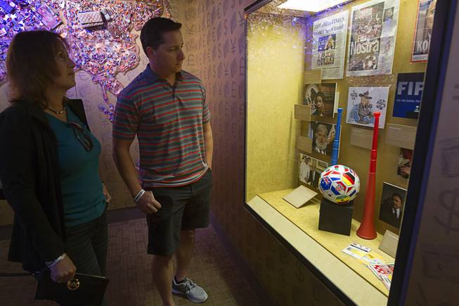 Beth Wilson of Houston and Mark Perino of Modesto, Calif. look over a display at "The Beautiful Game Turns Ugly," a new exhibit on the FIFA scandal at the The Mob Museum, the National Museum of Organized Crime and Law Enforcement in downtown Las Vegas Tuesday, Sept. 1, 2015.