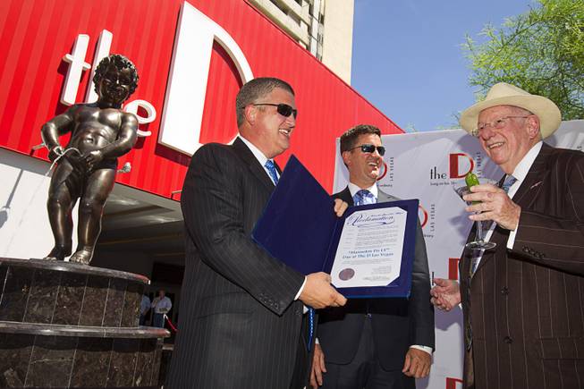 The D Las Vegas owners Derek Stevens and and Greg Stevens talk with former Las Vegas Mayor Oscar Goodman during an unveiling ceremony for the Manneken Pis Las Vegas statue at The D Las Vegas on Tuesday, Sept. 1, 2015, in downtown Las Vegas.