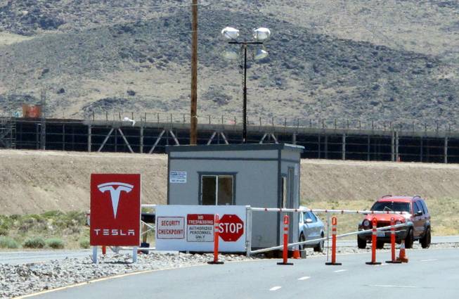 Framing of Tesla Motors’ new factory under construction is visible June 14, 2015, behind a security gate on Electric Avenue at Tahoe Reno Industrial Center about 15 miles east of Sparks along U.S. Interstate 80.