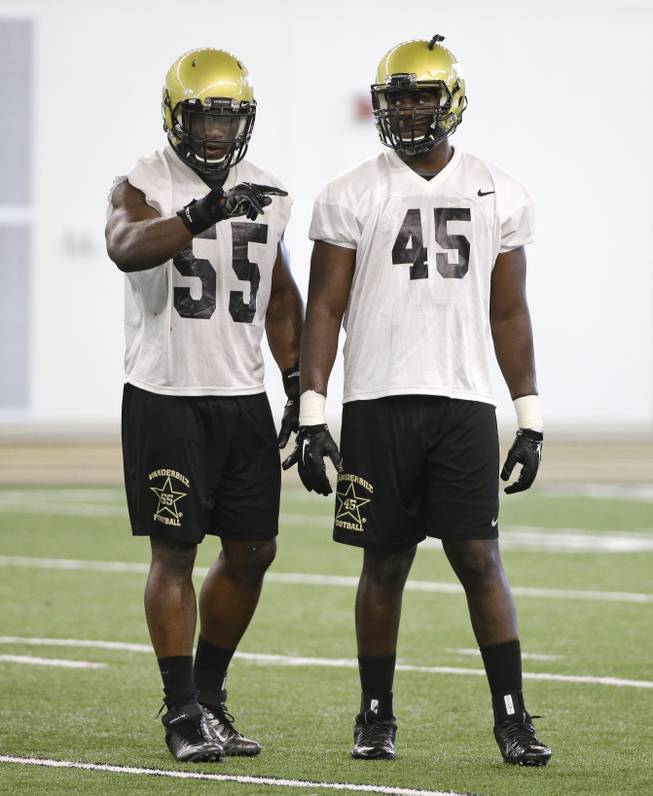 Vanderbilt defensive end Caleb Azubike (55) and linebacker Stephen Weatherly (45) wait for a drill during NCAA college football practice Thursday, Aug. 6, 2015, in Nashville, Tenn. 
