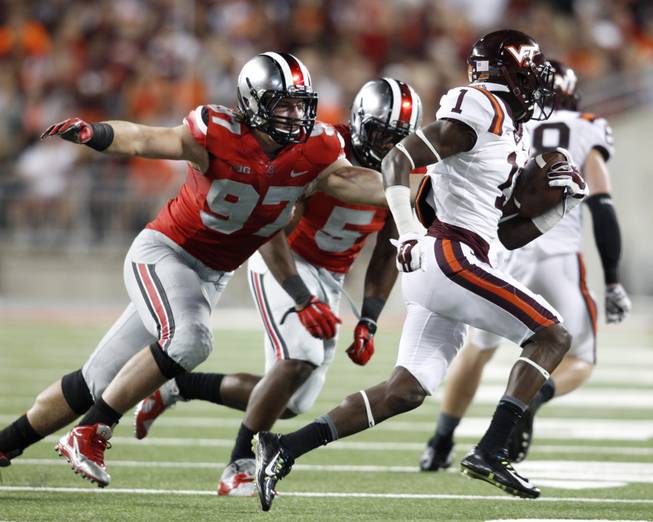 Ohio State lineman Joey Bosa (97) and linebacker Raekwon McMillian (5) chase Virginia Tech receiver Isaiah Ford (1) during an NCAA college football game in Columbus, Ohio.