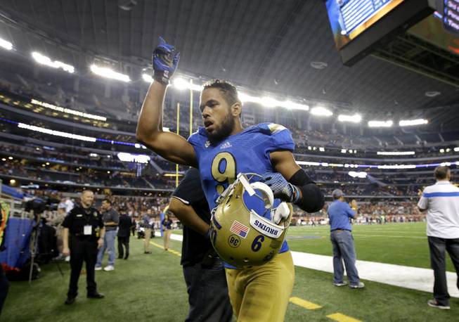 UCLA wide receiver Jordan Payton (9) celebrates as he jogs off the field after an NCAA college football game against Texas, Saturday, Sept. 13, 2014, in Arlington, Texas.