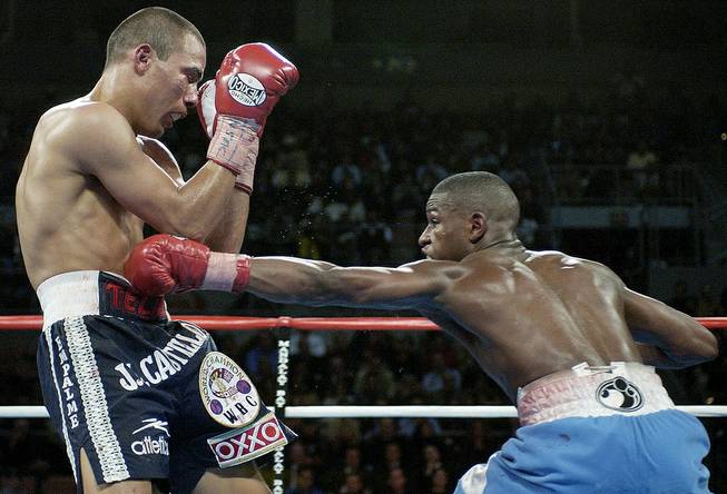 Floyd Mayweather lands a left to Jose Luis Castillo of Mexico during their WBC lightweight fight at Mandalay Bay Resort in Las Vegas on Saturday, Dec. 7, 2002. Mayweather defeated Castillo by unanimous decision.