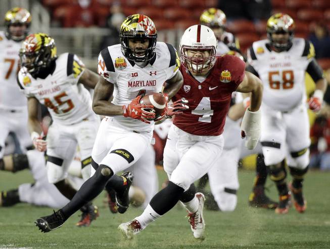 Maryland wide receiver Stefon Diggs is chased by Stanford linebacker Blake Martinez after a reception during the first half of the Foster Farms Bowl NCAA college football game Tuesday, Dec. 30, 2014, in Santa Clara, Calif.