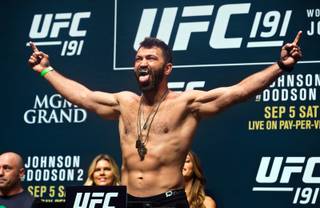 Andrei Arlovski, the No. 4 UFC heavyweight contender, poses with silver fangs before the fans during the UFC 191 weigh ins at the MGM Grand Casino on Friday, September 4, 2015.