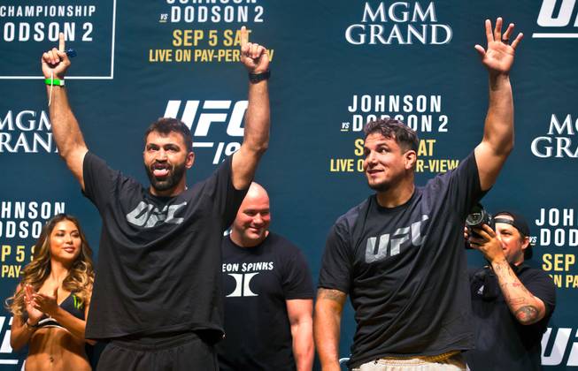 Andrei Arlovski, the No. 4 UFC heavyweight contender, and Frank Mir, the No. 10 UFC heavyweight contender, greet the fans during the UFC 191 weigh ins at the MGM Grand Casino on Friday, September 4, 2015.