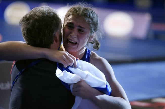 Natalia Vorobeva of Russia hugs her coach as she celebrates her win over Feng Zhou of China during their 69-kilogram women's freestyle championship match at the wrestling world championships Wednesday, Sept. 9, 2015, at the Orleans Arena in Las Vegas. CREDIT: Sam Morris/Las Vegas News Bureau
