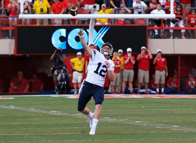 BYU quarterback Tanner Mangum throws a 42-yard Hail Mary with no time left, which was caught for the game-winning touchdown by wide receiver Mitch Mathews, unseen, giving BYU a 33-28 victory over Nebraska in an NCAA college football game in Lincoln, Neb., Saturday, Sept. 5, 2015. 