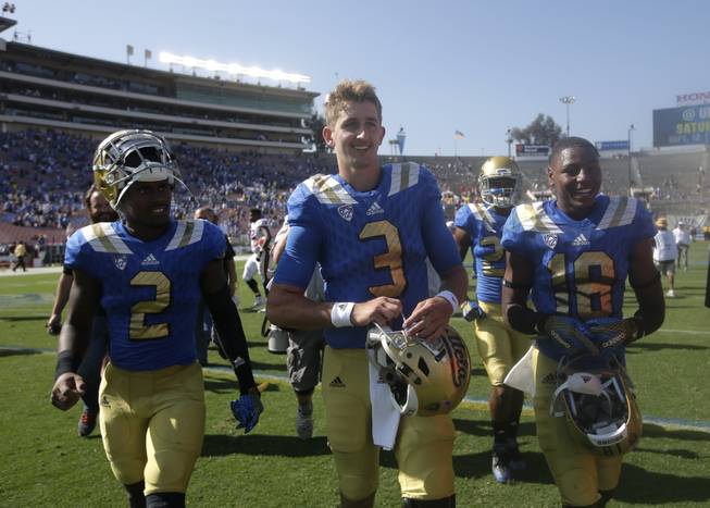 UCLA quarterback Josh Rosen, center, walks off the field after a game against Virginia at the Rose Bowl, Saturday, Sept. 5, 2015, in Pasadena, Calif. UCLA won 34-16.
