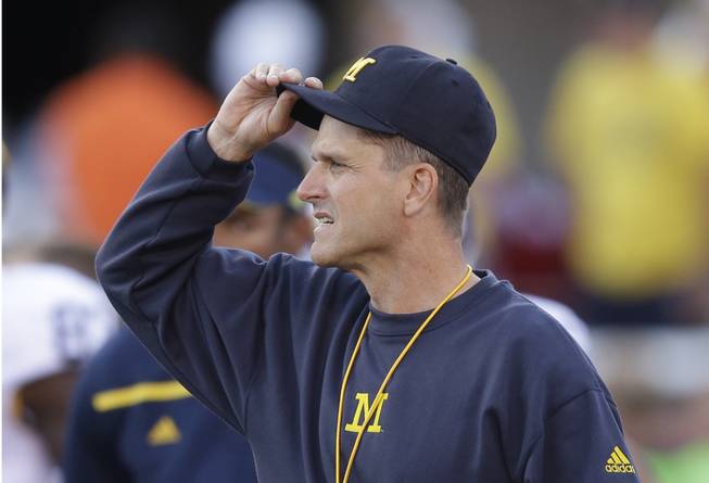 Michigan head coach Jim Harbaugh looks on before the start of their NCAA college football game against Utah Thursday, Sept. 3, 2015, in Salt Lake City.