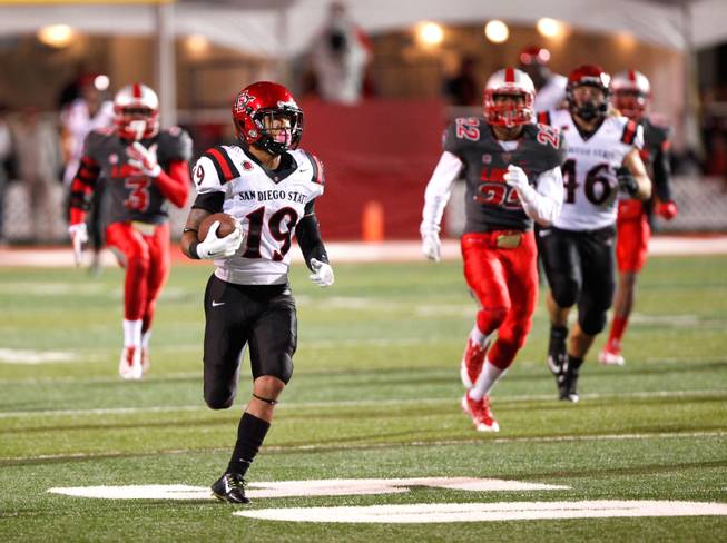 San Diego State's  Donnel Pumphrey runs 94-yards for a touchdown  against New Mexico during the second half of an NCAA college football game Friday, Oct. 10, 2014 in Albuquerque, N.M. Pumphrey rushed for a career-high 246 yards on 20 carries. San Diego State won 24-14. (AP Photo/Eric Draper)