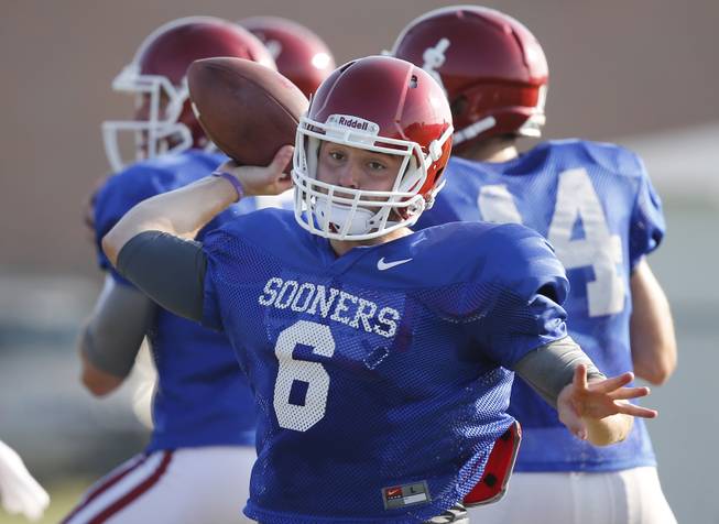 In this Tuesday, Aug. 5. 2014 photo, Oklahoma quarterback Baker Mayfield throws during a team practice in Norman, Okla. (AP Photo/Sue Ogrocki)